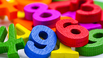 A pile of wooden number blocks for learning to count.